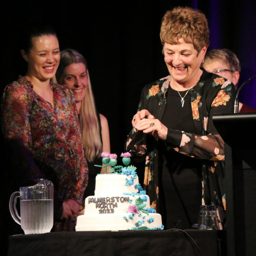 Sherilyn Hall cutting conference cake
