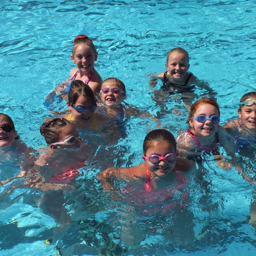 Dancers relaxing in the pool between classes